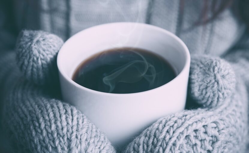 person holding white ceramic mug