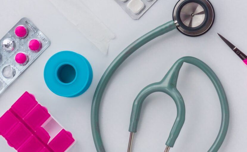 green and silver stethoscope on white envelope